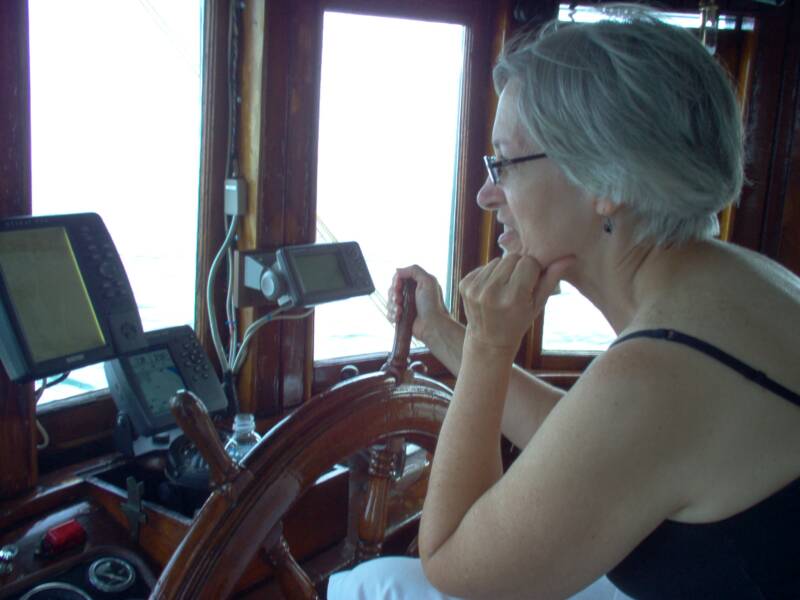 Oyster Buyboat PropWash, Brenda at Helm.jpg